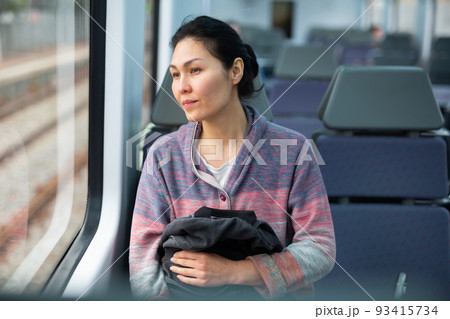 Portrait of woman traveling in urban trai 93415734