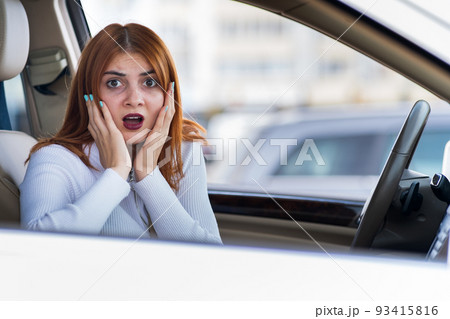 Closeup portrait of pissed off displeased angry aggressive woman driving a car shouting at someone. Negative human expression consept. 93415816