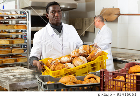 African baker carrying box with baked bread African baker carrying box with baked bread 93416061
