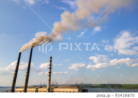 Aerial view of coal power plant high pipes with black smokestack polluting atmosphere. Electricity production with fossil fuel concept. Aerial view of coal power plant high pipes with black smokestack polluting atmosphere. Electricity production with fossil fuel concept. 93416870