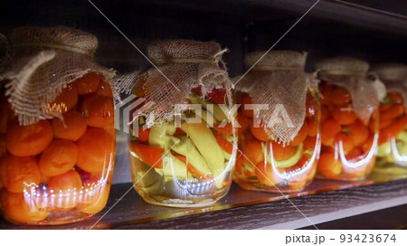 Food supplies at home, for quarantine. Jars of pickles are on the shelves. Jars of vegetables on the shelf. Stocks of vegetables in banks on a shelf. Food supplies at home, for quarantine. Jars of pickles are on the shelves. Jars of vegetables on the shelf. Stocks of vegetables in banks on a shelf. 93423674