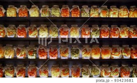 Food supplies at home, for quarantine. Jars of pickles are on the shelves. Jars of vegetables on the shelf. Stocks of vegetables in banks on a shelf. Food supplies at home, for quarantine. Jars of pickles are on the shelves. Jars of vegetables on the shelf. Stocks of vegetables in banks on a shelf. 93423681