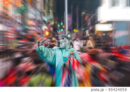 Night view of the Times Square street with street artists and huge crowd with motion blur effect Night view of the Times Square street with street artists and huge crowd with motion blur effect 93424059