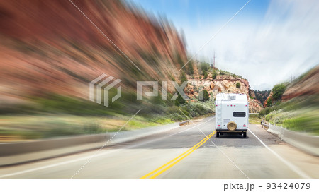 Motorhome going On Road with Background Of Mountains with motion blur effect 93424079