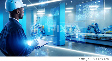 近未来の工場・倉庫で機械の情報をタブレットで点検するエンジニア 近未来の工場・倉庫で機械の情報をタブレットで点検するエンジニア 93425420