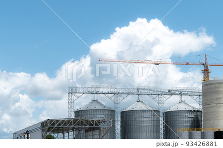 Animal feed factory construction site. Agricultural silo at feed mill factory. Tank for store grain in feed manufacturing. Seed stock tower for commercial animal feed production. Animal food industry. 93426881