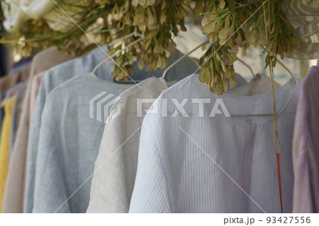 Organic eco clothes on a hanger. Home-made clothing from natural and processed fabrics, natural vegetable ingredients. Eco-friendly dresses and shirts 93427556