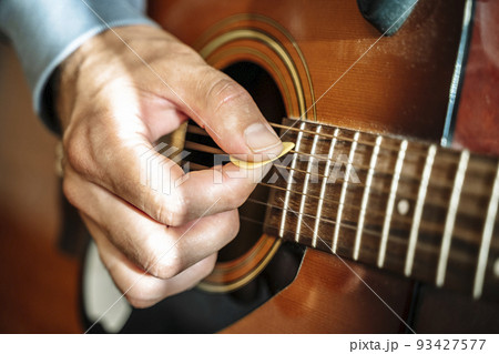 Playing the acoustic guitar. The musician plays country rock and blues on a classical acoustic guitar. Music, creativity, sound concept. 93427577