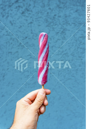Ice cream cone in hand on minimal color background isolated. Summer, food, sweets, ice cream concept. 93427601