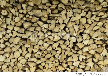 Firewood background. Sawn trunks and logs of needles and birch for making a fire and decor. Firewood background. Sawn trunks and logs of needles and birch for making a fire and decor. 93427729