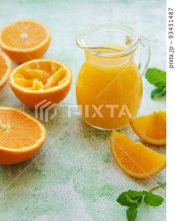 Glass jug of fresh orange juice 93431487