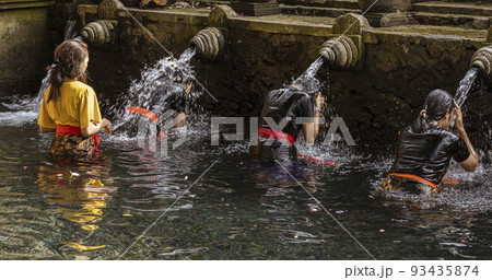 Bali, Indonesia, June 1, 2022 - People receive blessing at the Water Temple in Bali aka Tirta Empul 93435874