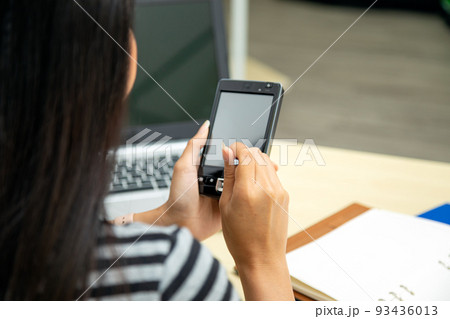 Asian woman hands using stylus pen writing on personnal pda to check information Asian woman hands using stylus pen writing on personnal pda to check information 93436013