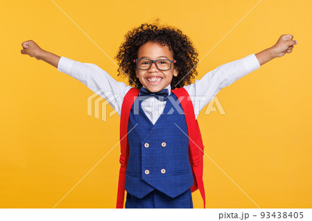 Happy ethnic schoolboy in glasses celebrating success 93438405