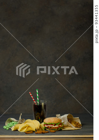 Drinks in a paper cup with a paper tube and hamburger Drinks in a paper cup with a paper tube and hamburger 93441355