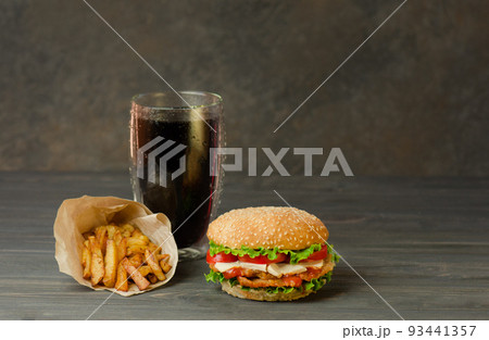 Hamburger, french fries and cola on table with wooden background. Hamburger, french fries and cola on table with wooden background. 93441357