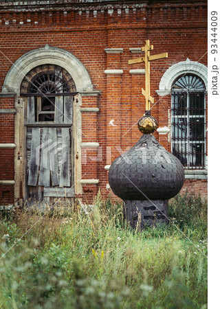 Old russsian chirch tip with golden cross separate bring down on ground chirch background Old russsian chirch tip with golden cross separate bring down on ground chirch background 93444009