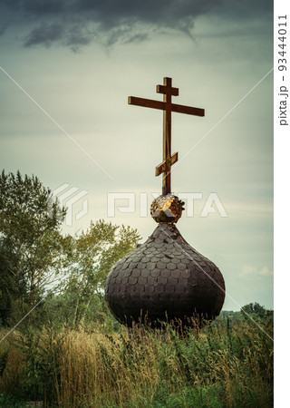 Old russsian chirch tip with golden cross separate bring down on ground and grass 93444011
