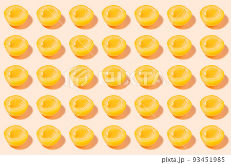 Halves of ripe apricots on a pink background - summer background - fruit harvest concept Halves of ripe apricots on a pink background - summer background - fruit harvest concept 93451985