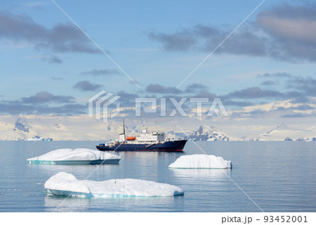 Expedition ship with iceberg in Antarctic sea aerial view  93452001
