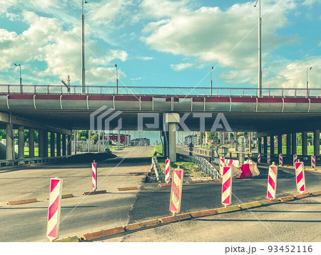 road construction in the city center. laying communications. bridge with a protective fence from foreign vehicles. concrete bridge for the passage of vehicles and people 93452116