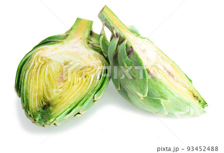 two halves of ripe green artichokes on a white background two halves of ripe green artichokes on a white background 93452488