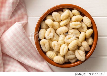Uncooked potato gnocchi in bowl. Tasty italian food. Uncooked potato gnocchi in bowl. Tasty italian food. 93454840