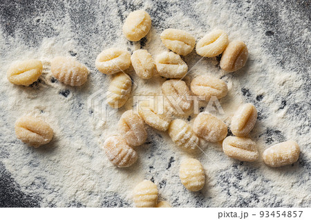 Uncooked potato gnocchi on kitchen table. Tasty italian food. 93454857