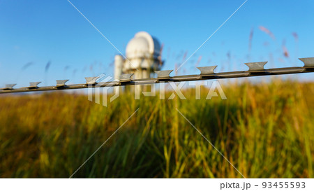 A large observatory is protected by a barbed fence 93455593