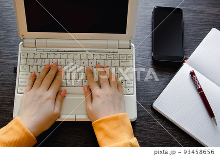 Modern businesswoman works on laptop. Workspace in office at desk. Modern businesswoman works on laptop. Workspace in office at desk. 93458656