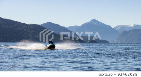 Adventurous Caucasian Woman on Water Scooter riding in the Ocean Adventurous Caucasian Woman on Water Scooter riding in the Ocean 93462038
