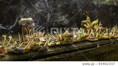 Indonesia - Incense being burned in offering in several offering baskets 93462337