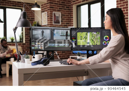 Content creator working with video editing software to create professional montage with audio and visual effects. Videographer using post production footage to edit film or movie. Content creator working with video editing software to create professional montage with audio and visual effects. Videographer using post production footage to edit film or movie. 93464545