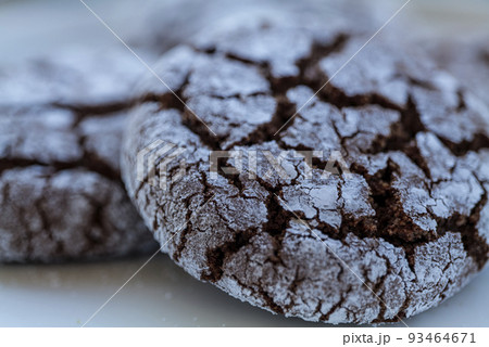 Homemade almond cookies with cocoa sprinkled with powdered sugar on a plate 93464671