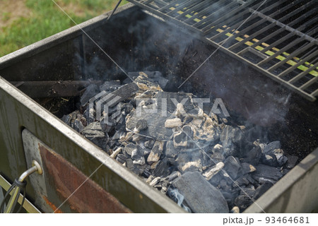 Home barbecue with charcoal in the backyard grilling steaks and other meats 93464681