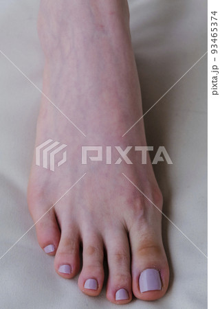 Close-up of female feet painted grey nail polish, self made pedicure at home. 93465374