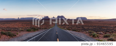 Scenic Road in the Dry Desert with Red Rocky Mountains in Background. 93465595