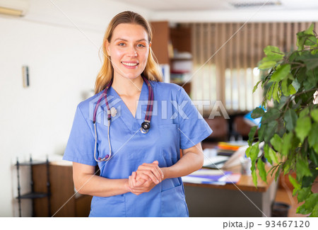 Positive female doctor posing in private clinic Positive female doctor posing in private clinic 93467120
