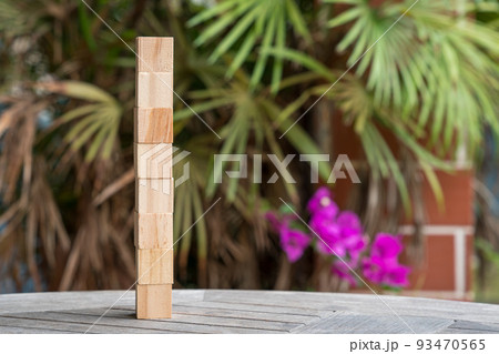 Eight blank wooden block cubes stacked in vertical position. 93470565