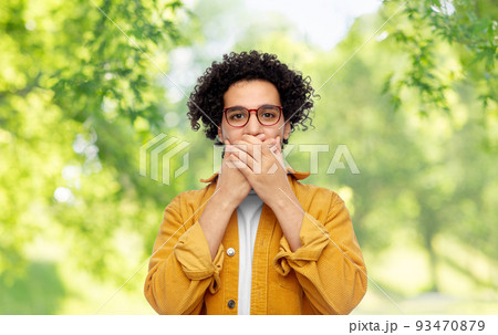 man covering mouth by hands on natural background man covering mouth by hands on natural background 93470879