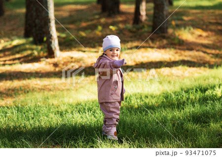 happy little baby girl walking in autumn park happy little baby girl walking in autumn park 93471075