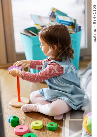 happy baby girl playing with toy pyramid at home happy baby girl playing with toy pyramid at home 93471108