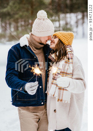 happy couple with sparklers in winter forest happy couple with sparklers in winter forest 93471122