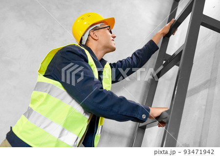 builder or worker in helmet climbing ladder builder or worker in helmet climbing ladder 93471942