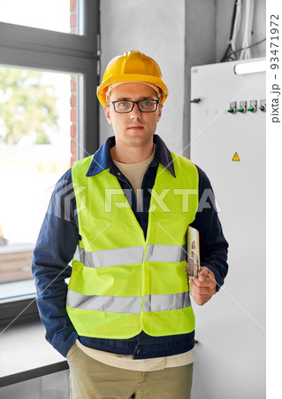 electrician with clipboard at electric board electrician with clipboard at electric board 93471972
