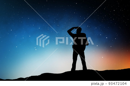 traveler standing on edge and looking far away 93472104