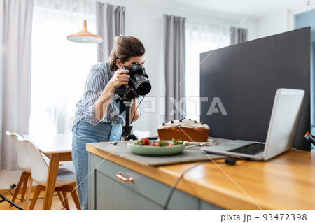 food photographer with camera working in kitchen food photographer with camera working in kitchen 93472398