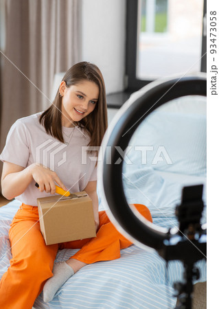 happy girl blogger unpacking parcel box at home happy girl blogger unpacking parcel box at home 93473058
