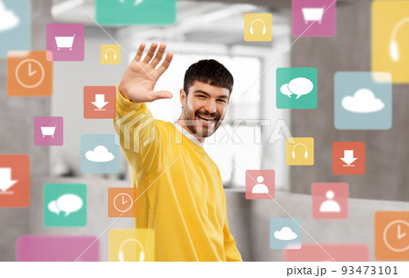 smiling young man in yellow sweatshirt waving hand smiling young man in yellow sweatshirt waving hand 93473101