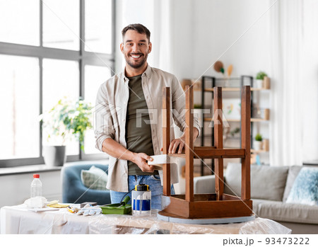 man sticking adhesive tape to table for repainting man sticking adhesive tape to table for repainting 93473222